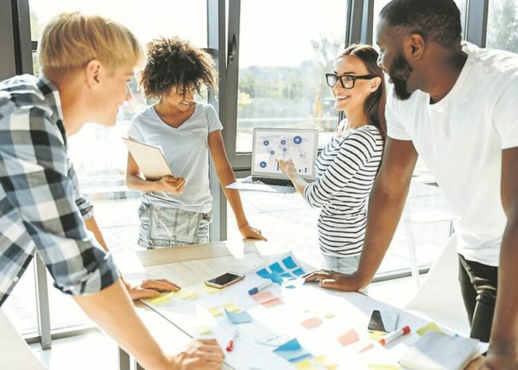 Trace the tendency. Cheerful enthusiastic young people discussing their business project and working together while expressing their ideas