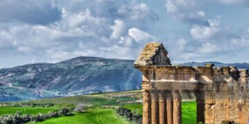 The archaeological site of Thugga/Dougga is located in the North-west region of Tunisia, perched on the summit of a hill at an altitude of 571 m, dominating the fertile valley of Oued Khalled. The impressive ruins give an idea of the resources of a Romanised Numidian town.